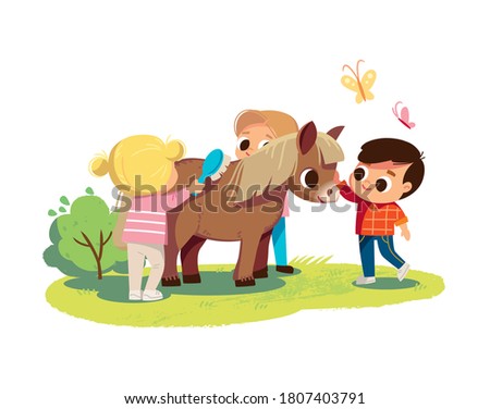 Little boy feed the pony. Girl brushing pony with comb. Kids with animals. Pets care. Summer background.