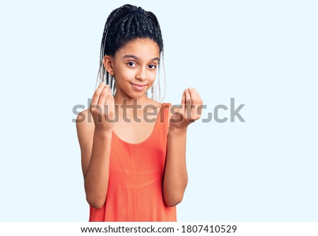Cute african american girl wearing casual clothes doing money gesture with hands, asking for salary payment, millionaire business 