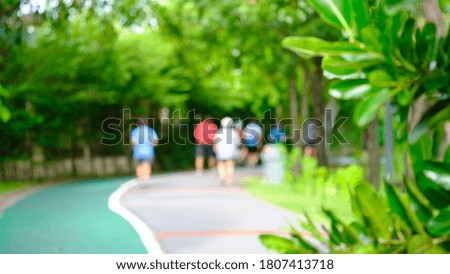 Blurred photo of people spend time in public park on greenery background, natural bokeh with daylight, concept, relaxing color and fresh atmosphere, photo for background or wallpaper
