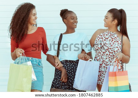 Happy group of friends shopping in spring and summer season. A picture of a group of happy girls shopping in the city.  White Background. Shopping and tourism concept.