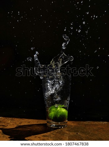 water splash with lemon in glass