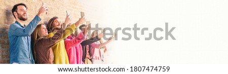 Group of young people using smartphones making selfie. Concept of new technology. horizontal web banner background template with copy space.