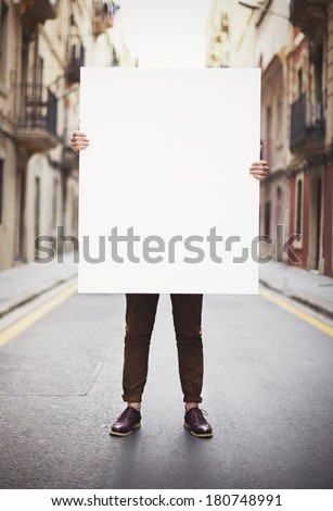 Man holding blank poster 