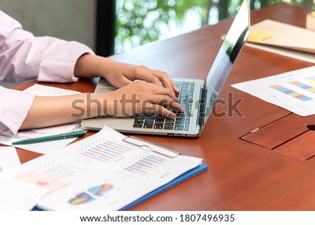 Hand typing data to connet and search information in business online at meeting room.
