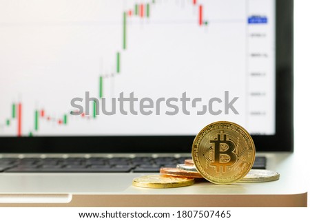 Photo Golden Bitcoins (new virtual money cryptocurrency). Bitcoins and New Virtual money concept. Golden bitcoins with Candle stick graph chart and digital background. Golden coin with icon letter B.