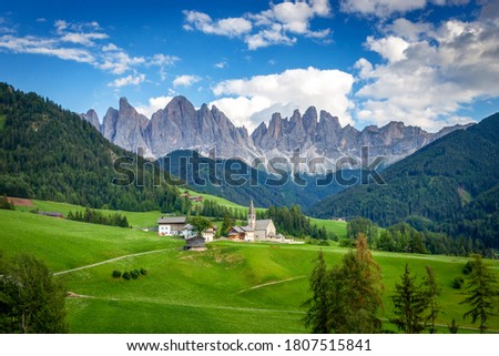 Panorama of Santa Maddalena village and Church in front of Odles group - Geislergruppe and Seceda mountain, Funes valley, Dolomites, Trentino South Tyrol, Italy Royalty-Free Stock Photo #1807515841