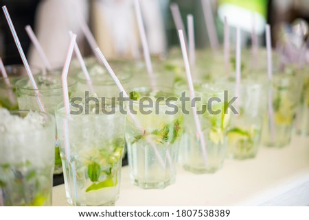 Close up photo of fresh mojito cocktails on bar table during summer time