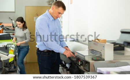 Portrait of male worker at plotter. High quality photo