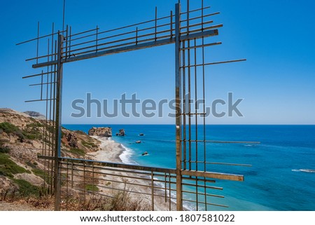 Petra tou Romiou, famous as the birthplace of Aphrodite in Paphos, Cyprus seen thorugh a metal construction acting as a picture frame