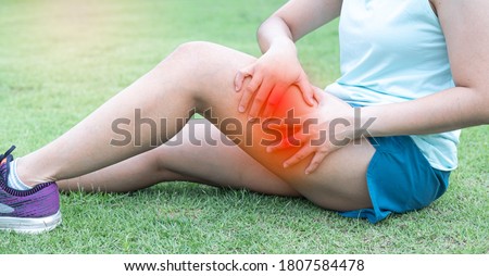Thigh muscle pain caused by strenuous exercise. This injury is often caused by a variety of sports such as running, soccer, basketball, etc. Royalty-Free Stock Photo #1807584478