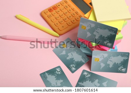 Credit cards and stationery on pink background
