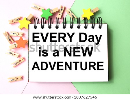 Every day is a new adventure, TEXT ON WHITE PAPER ON MULTI-COLORED PAPER near clothespins