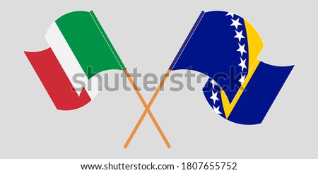 Crossed and waving flags of Italy and Bosnia and Herzegovina