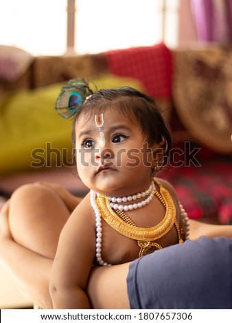 Baby girl dressed up like lord krishna/gopal on the occasion of janmashtami.