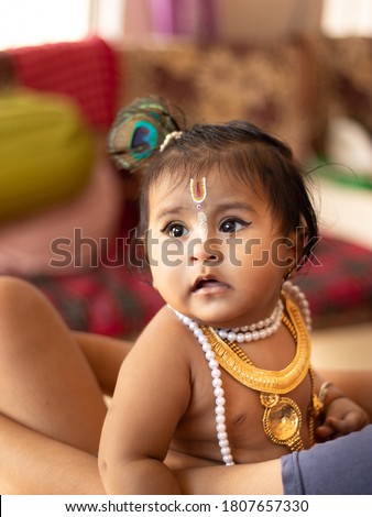 Baby girl dressed up like lord krishna/gopal on the occasion of janmashtami.