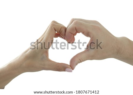 Male and female hand make heart shape on background of window. Love and understanding in a relationship concept