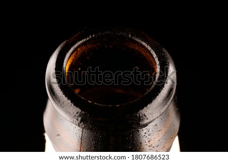 The neck of the beer bottle is a dark key