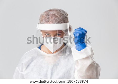 Medical workers, covid-19 pandemic, coronavirus concept. Close-up of confident and hopeful female doctor in personal protective equipment clench fist in support, endorse, rejoicing over victory