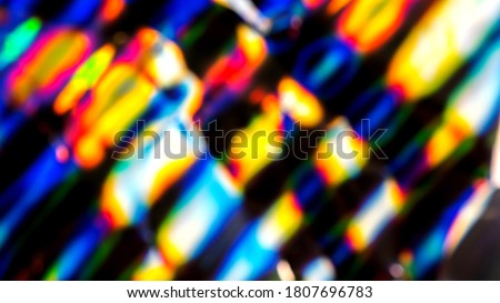 Out of focus photo lens overlays heavy grain noise abstract hologram vivid colorful texture background.
