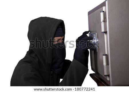 Portrait of a robber trying to open a safe isolated over white