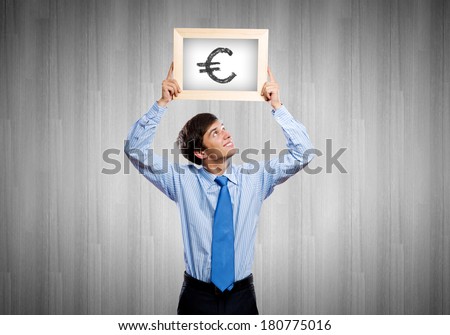 Handsome man holding frame with euro sign
