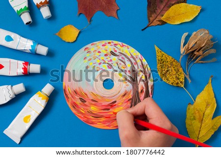 Painting with acrylics paints on CD. Seasons. Autumn landscape. Creative art project 
