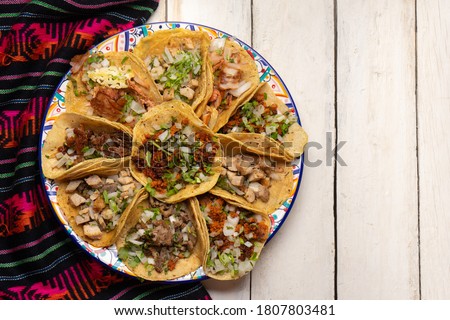 Assortment of traditional mexican tacos on white background
