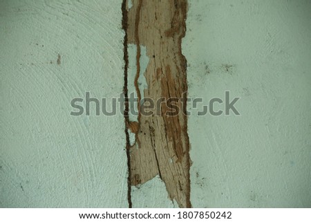 Abstract background image from a cement wall with a wooden stick.