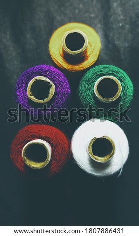 Colorful yarn on spool, yarn on tube, cotton, wool, linen thread,Color sewing threads on white background, top view