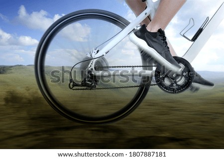 Side view of a woman riding a bicycle on the meadow field