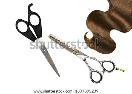 scissors and hair on a white background. Hairdressing equipment