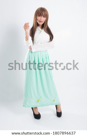 Korean woman wearing traditional korean dress on white background in studio. Beautiful Korea culture.