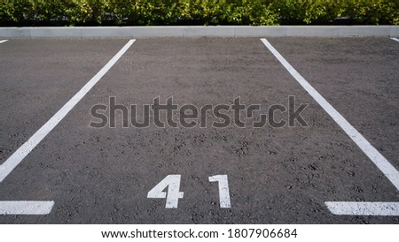 Close-up of a white paint number marking in a parking lot. Empty parking lot, Parking lot with white mark, Open parking in public park. Number 41