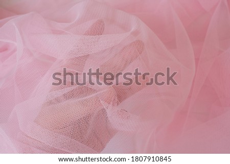 Soft pink color tulle fabric texture seamless with beautiful closeup and elegance detail fabric background. Luxury tulle textile pattern with soft vintage material.