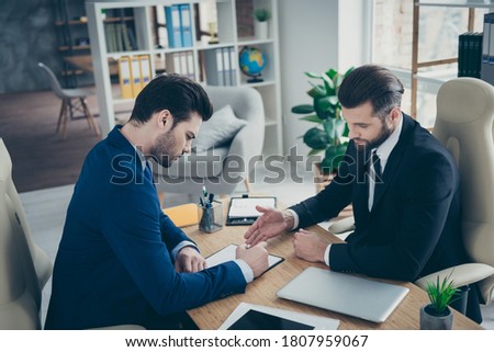 Portrait of two nice attractive handsome classy elegant trendy men economist signing employment contract offer recruiting in light white interior work place station indoors