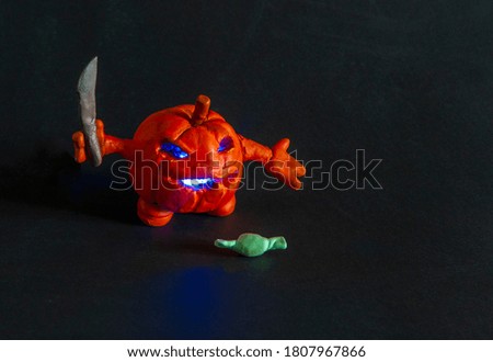pumpkin character with glowing eyes on a dark background