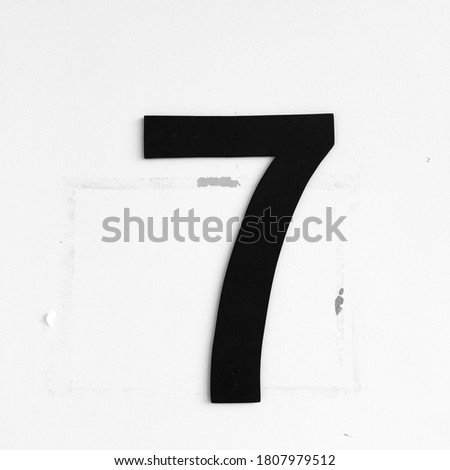 Number 7 on white cement floor.