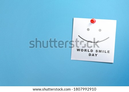 Paper with World Smile Day message hanging on the wall. World Smile Day