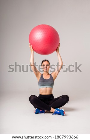 athlete hold fitness ball on a white isolated background