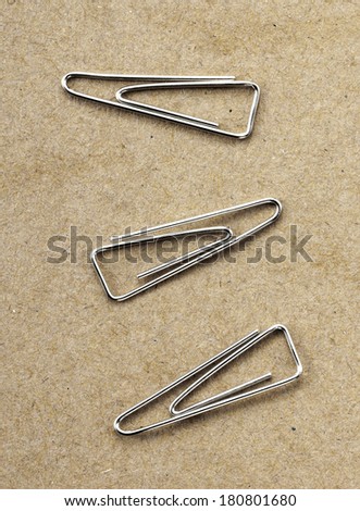 Paperclips on yellow background texture