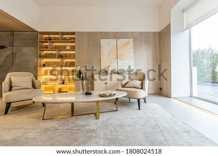 modern interior design of the living area in the studio apartment in warm soft colors. decorative built-in lighting and soft beige furniture Royalty-Free Stock Photo #1808024518