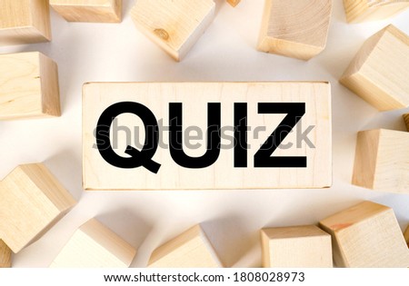 quiz. text on wood block near wood cubes