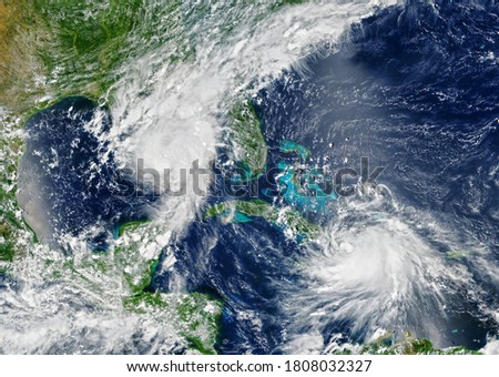 Hurricanes are approaching USA,  tropical storms over sea in satellite photo. View of typhoons of Earth from space. Weather forecast, season, aerial photography. Elements of image furnished by NASA