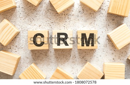 The word consists of wooden cubes with letters, top view on a light background.