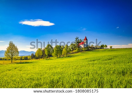 Rural landscape with a church in the background. Saint Kosmas Church in Abramova village, Turiec Region, Slovakia, Europe.