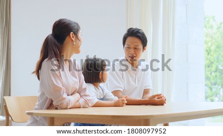 Asian parents talking with the daughter