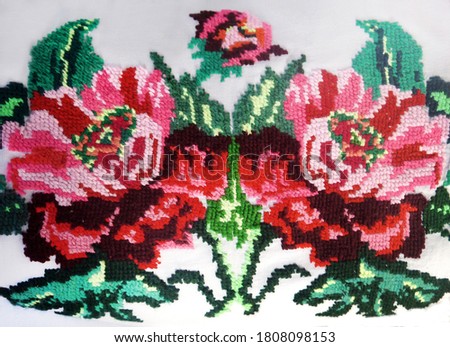 Embroidered flowers on the fabric. Ukrainian folk hand embroidery. On white background