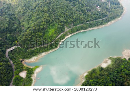 aerial view of a road with trees near the lake in Mingtan Reservoir, Shuili town, Nantou, Taiwan