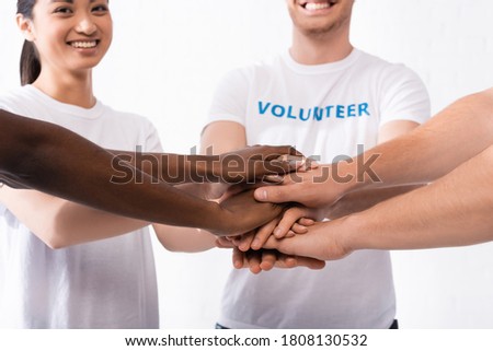 Selective focus of multicultural volunteers holding hands