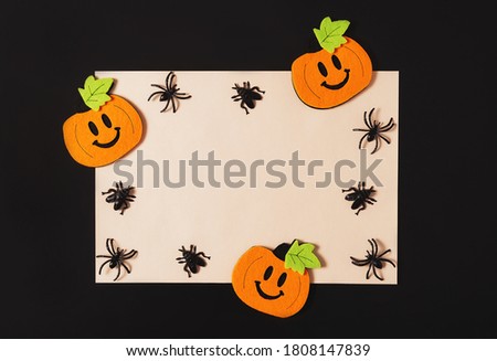 Cartoon Halloween background white vintage yellow paper blank with black spiders and pumpkins on black backdrop. Copy space. Flat lay style. Halloween abstract background. Dark retro black and white